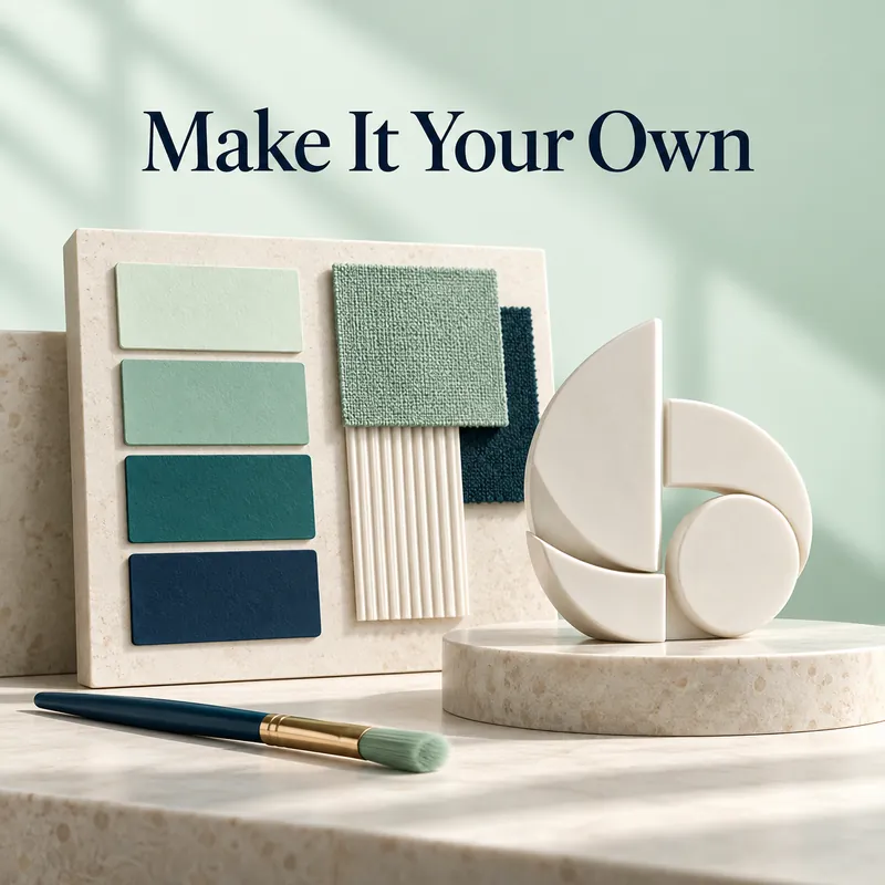Mint and teal color swatches beside a ceramic emblem and a fine brush.